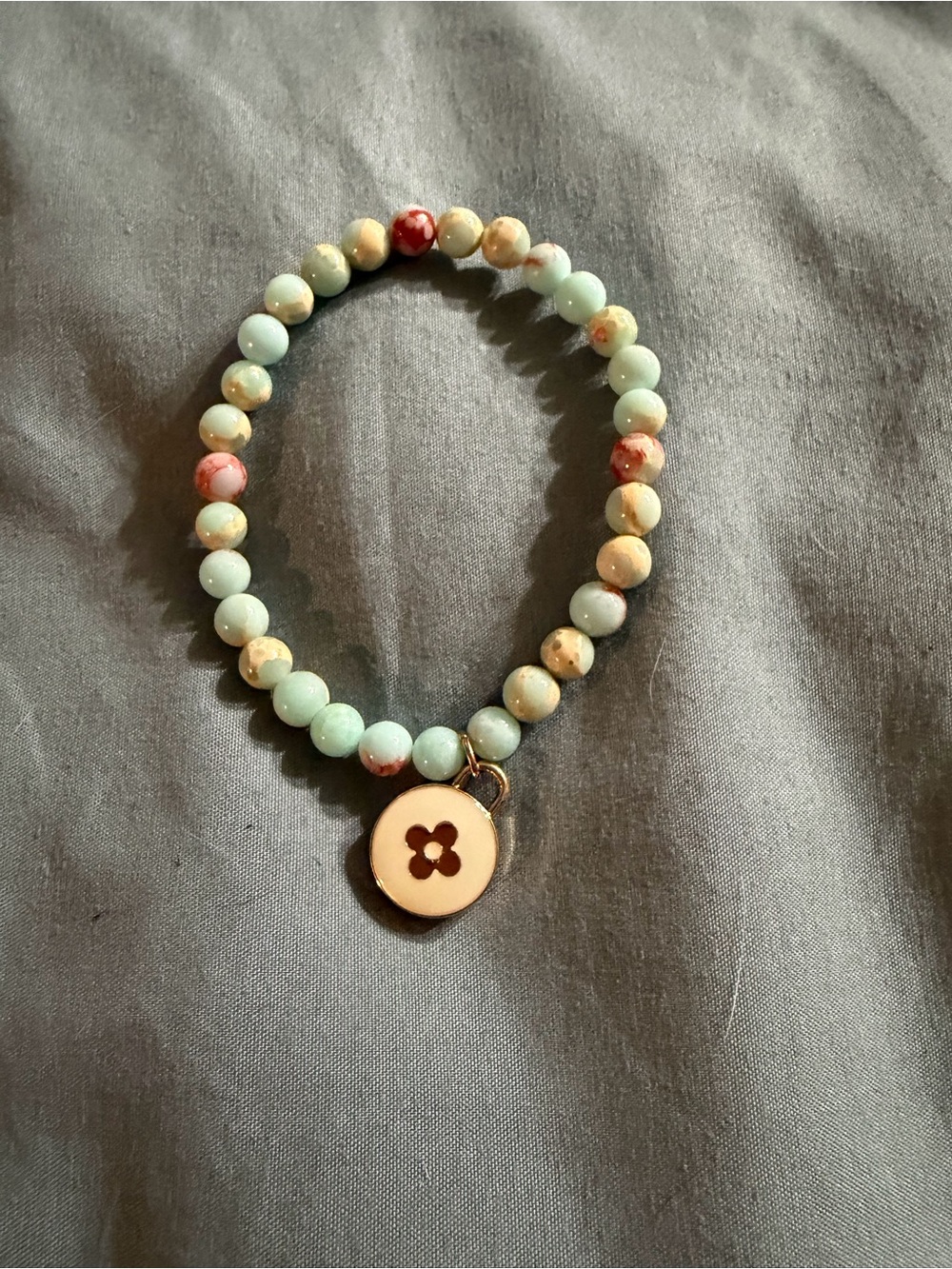 Hand Crafted Mint and Coral Beaded Bracelet with Gold Flower Charm